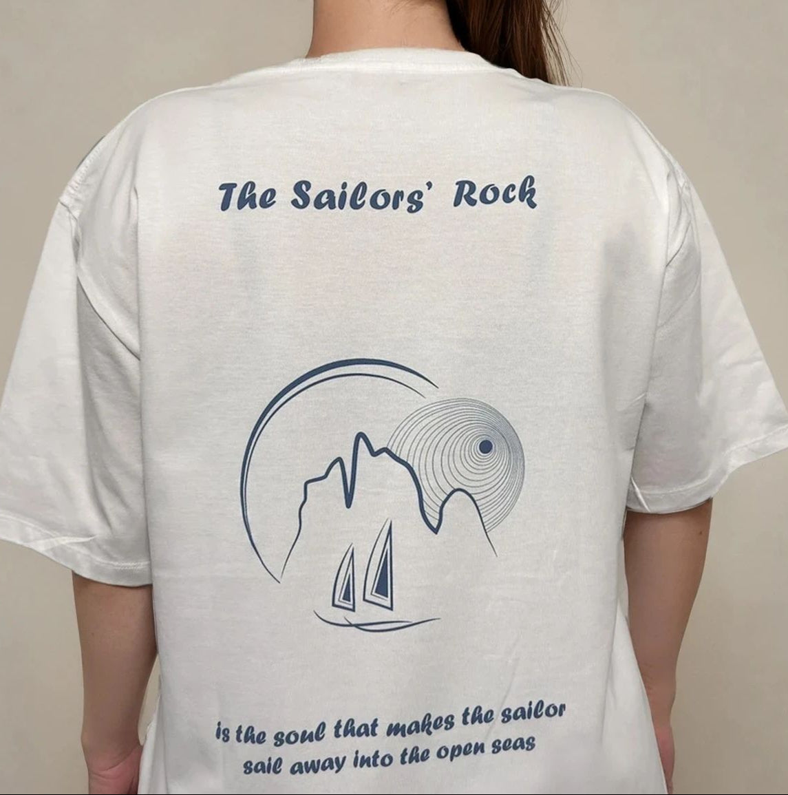 White t-shirt with 'The Sailors' Rock' design and text on a plain background